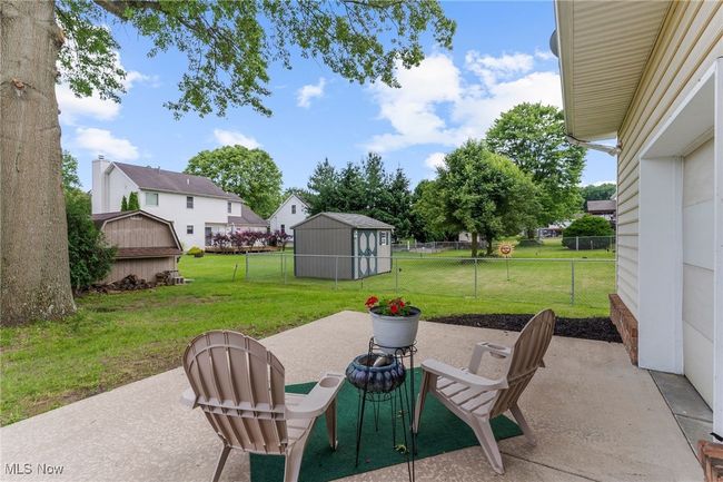 Fenced backyard featuring a patio area and a storage unit | Image 41