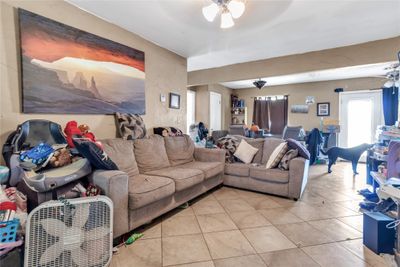 Tiled living room featuring ceiling fan | Image 3