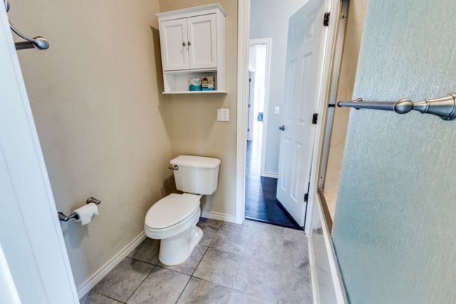 Bathroom featuring toilet, tile patterned flooring, and baseboards | Image 28