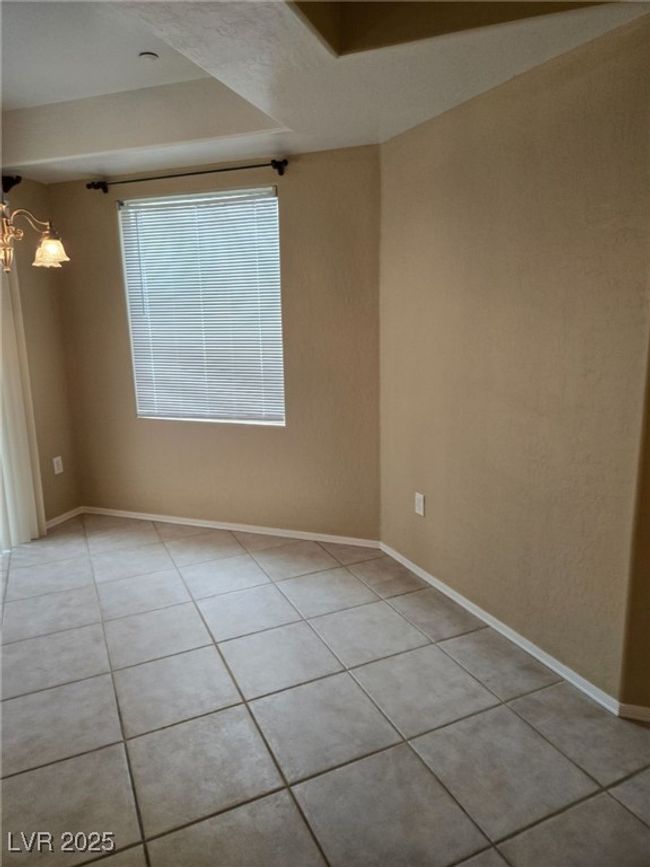 Spare room featuring light tile patterned floors, a chandelier, and baseboards | Image 18