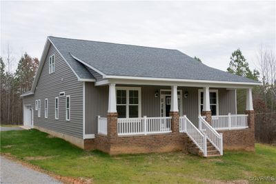 Craftsman house with a garage, covered porch, and a front lawn | Image 1