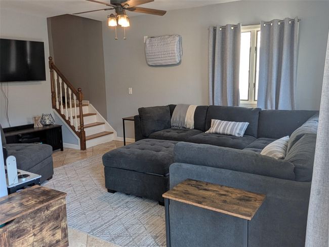 Living room with a ceiling fan, stairway to the upstairs | Image 14
