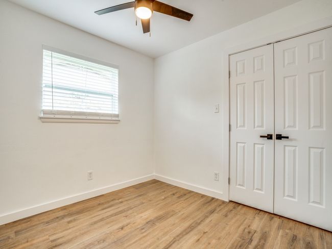Unfurnished bedroom with light wood-style floors, a closet, baseboards, and a ceiling fan | Image 13