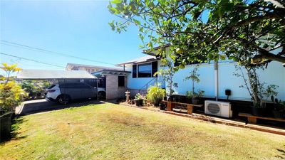 Front yard view with the view of the car port and driveway parking with shade | Image 2