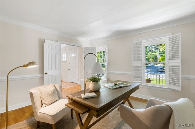 Another view of the Living room/Office area with hardwood flooring, ornamental molding, plantation shutters and bullt-ins not visible in this photo. | Image 8