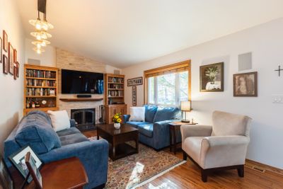 Lannon stone fireplace flanked by custom built in | Image 2