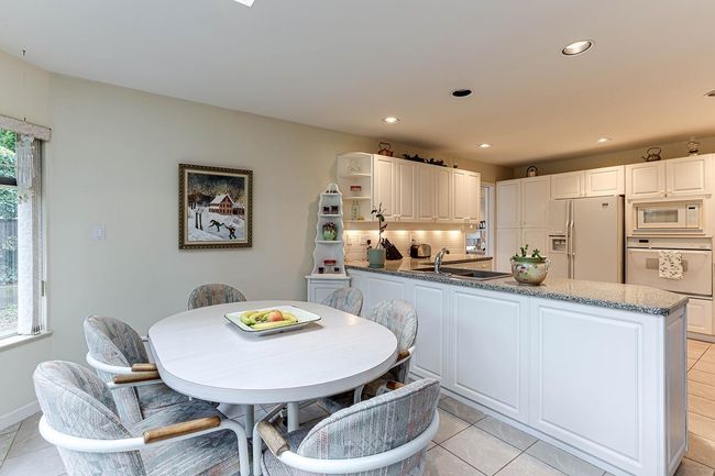 Kitchen with recessed lighting, white appliances, a sink, and open shelves | Image 15