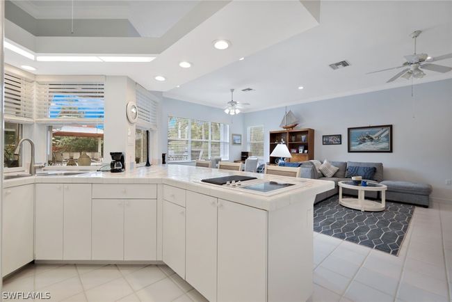 Kitchen with white cabinets, plenty of natural light, and ceiling fan | Image 23
