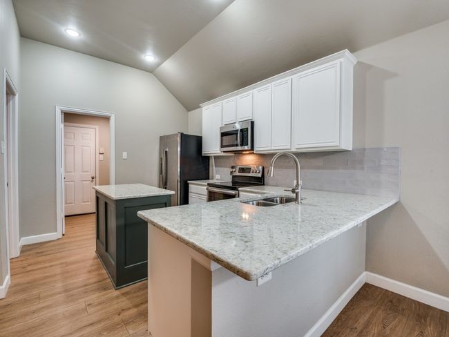 Kitchen featuring a breakfast bar | Image 10
