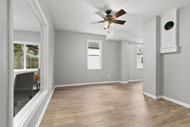 The living room gets great natural light from the large windows. | Image 10