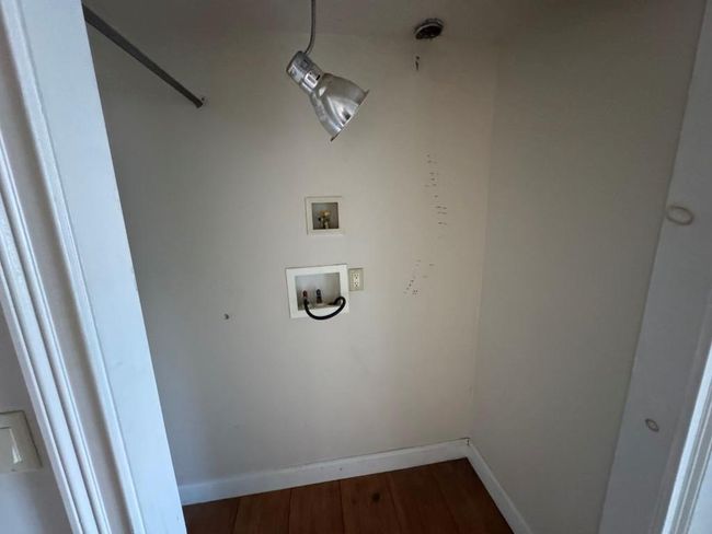 Laundry area with washer hookup, laundry area, baseboards, and wood finished floors | Image 11