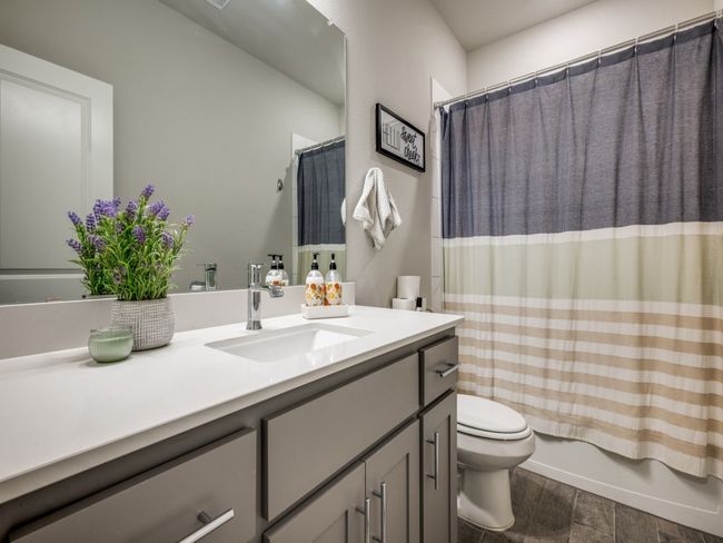 Guest bathroom offers a bath-tub combo and a large vanity sink! | Image 18