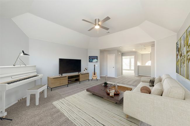Living room featuring light carpet, ceiling fan, lofted ceiling, and visible vents | Image 12