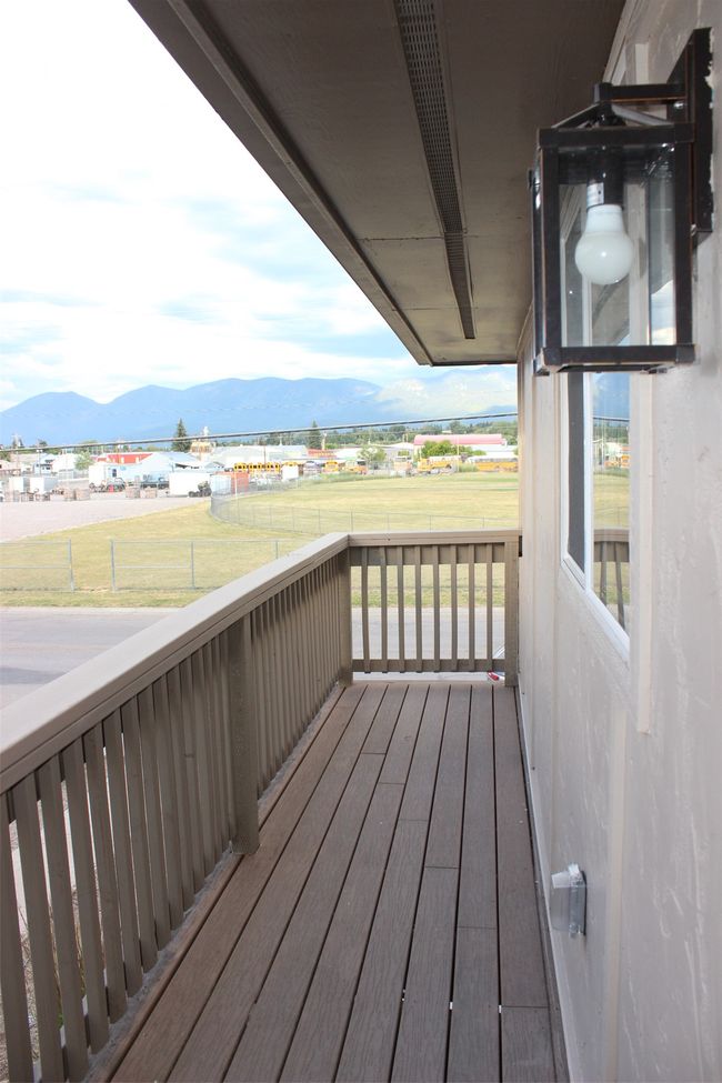 Wooden porch featuring a mountain view and a yard | Image 23