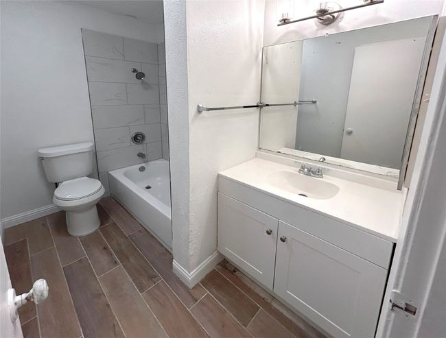 Primary bathroom featuring toilet, vanity, and shower / bath combination | Image 20