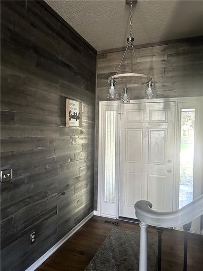 Entryway with shiplap walls and new light fixture. | Image 3