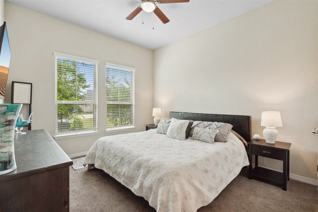Tucked away on the main floor, this guest bedroom offers the perfect space for in-laws or overnight visitors | Image 19