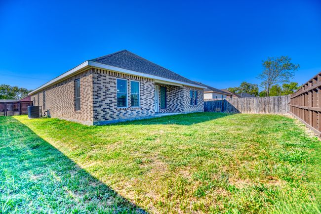 Back of house with central AC and a lawn | Image 37
