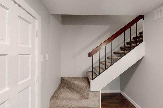 Stairs featuring baseboards, visible vents, and wood finished floors | Image 9