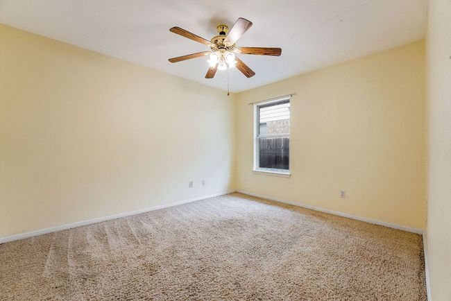 Empty room with baseboards, ceiling fan, and carpet flooring | Image 25