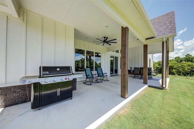 View of patio featuring area for grilling and ceiling fan | Image 30