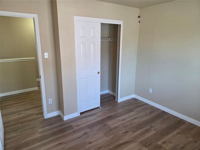 Unfurnished bedroom featuring dark wood-type flooring and a closet | Image 22