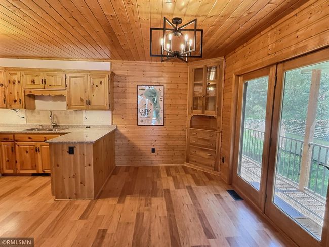 The covered side deck opens to the spacious dining room, what a space to enjoy all your meals and each other. | Image 10