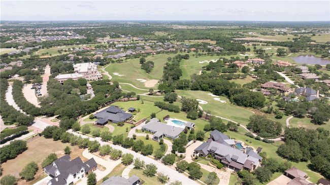 Aerial view of property's location with a golf club, a nearby body of water, and nearby suburban area | Image 29