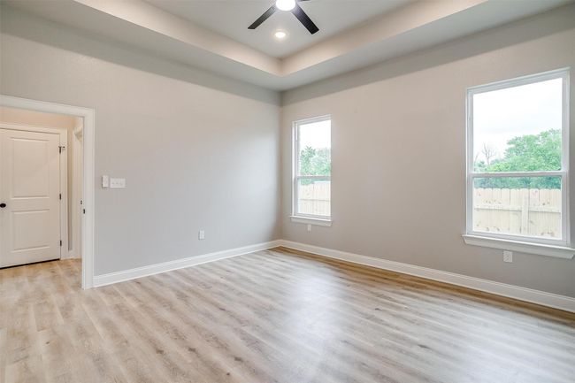 Spare room with ceiling fan, baseboards, and light wood-type flooring | Image 18
