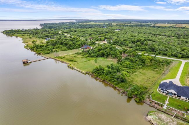 Bird's eye view of a nearby body of water and a forest | Image 9