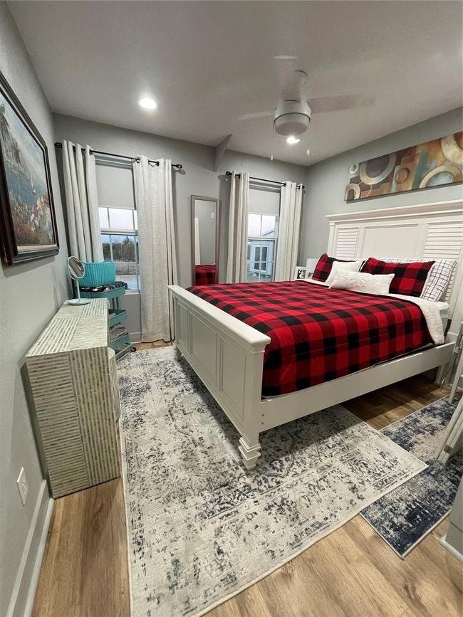 Bedroom featuring wood finished floors and multiple windows | Image 14