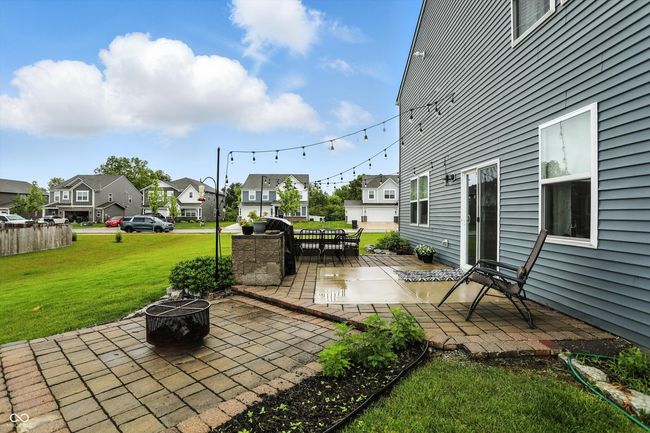 view of patio with an outdoor fire pit and a residential view | Image 37