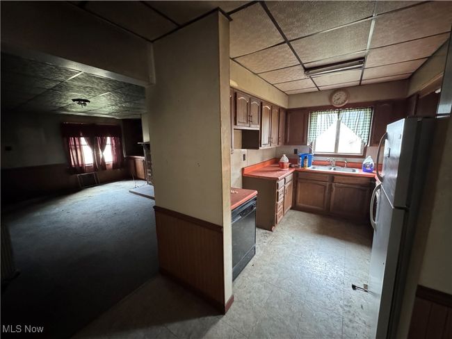 Kitchen with a sink, a paneled ceiling, and freestanding refrigerator | Image 4