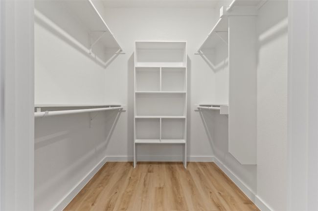 A modern, spacious primary closet with ample storage and sleek design—perfect for effortless organization | Image 18