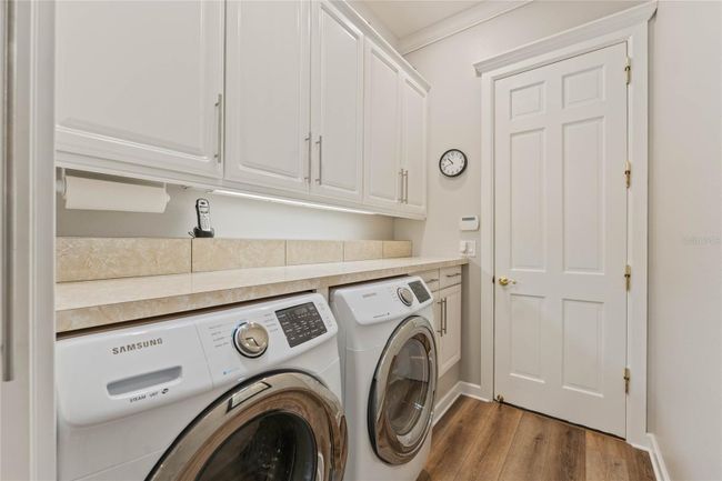 Indoor Laundry Room with Plenty of Storage Cabinets | Image 28