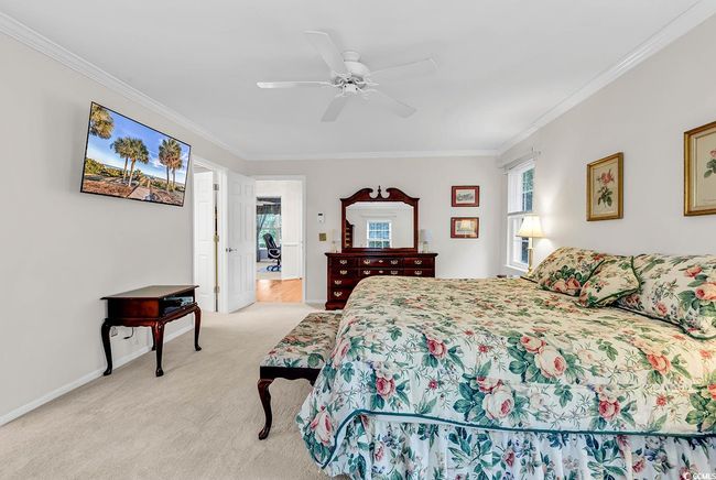 Bedroom featuring crown molding, multiple windows, light colored carpet, and a ceiling fan | Image 11