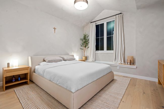 Bedroom with wood finished floors, baseboards, and vaulted ceiling | Image 18