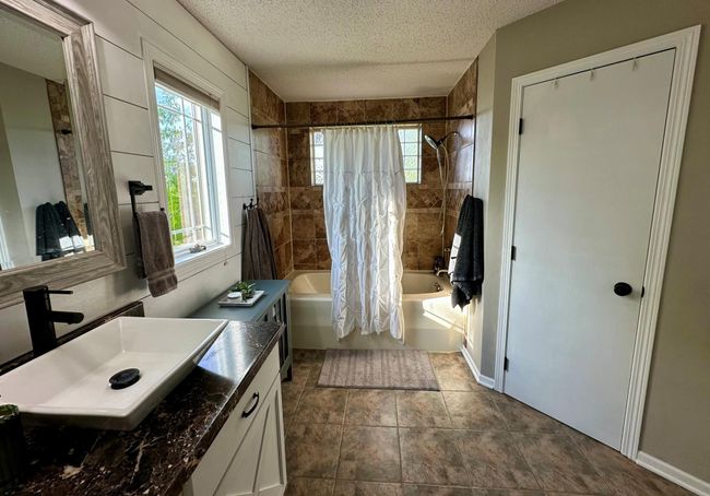 Main level bath with double sinks and jetted tub. | Image 11
