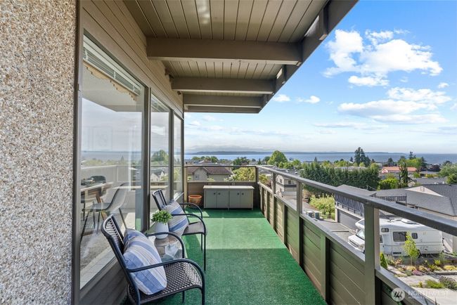 Wonderfully situated end unit with large deck, picture windows, covered parking, and more! | Image 24