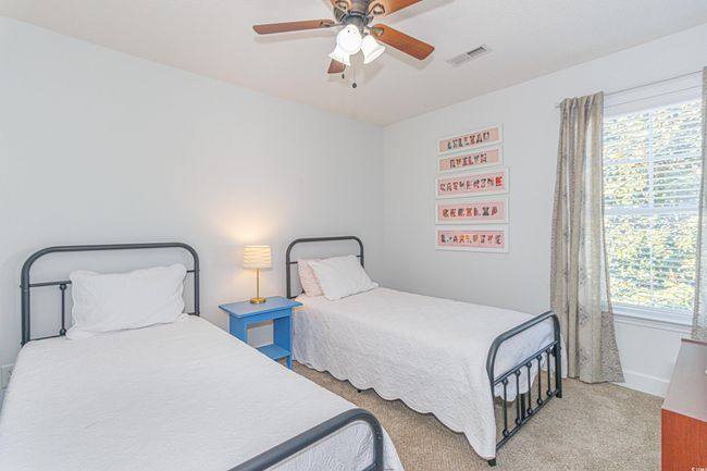 Carpeted bedroom with multiple windows and ceiling fan | Image 25