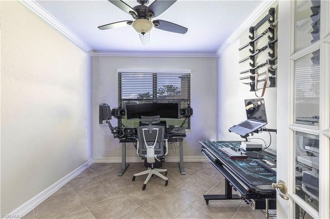 Office featuring tile patterned flooring, a ceiling fan, baseboards, and ornamental molding | Image 16