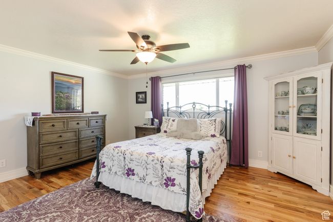 Bedroom featuring baseboards, ornamental molding, and light wood-type flooring | Image 18