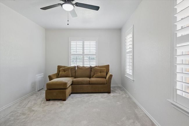 Living area featuring carpet flooring, a ceiling fan, and baseboards | Image 23