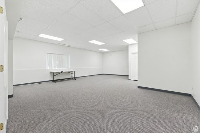 Empty room with a drop ceiling and carpet flooring | Image 17