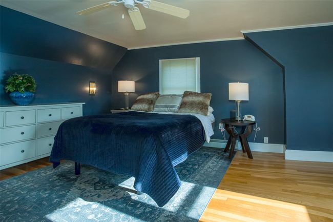 Bedroom featuring ceiling fan, crown molding, wood-type flooring, and vaulted ceiling | Image 18
