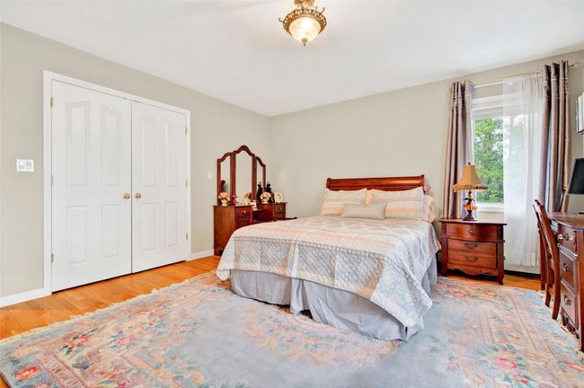 Bedroom featuring wood finished floors, a closet, and baseboards | Image 37