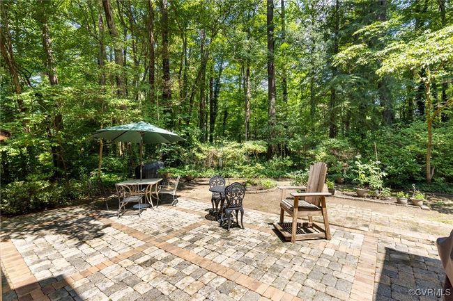 View of patio featuring outdoor dining space and a forest view | Image 38