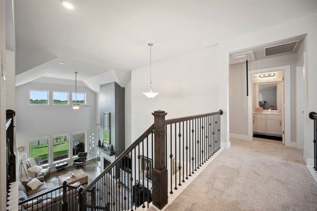 Hall featuring an upstairs landing, recessed lighting, light colored carpet, and lofted ceiling | Image 30