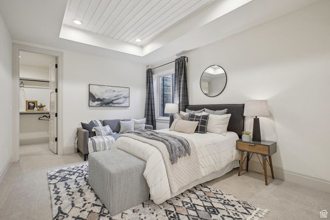 Bedroom featuring recessed lighting, a raised ceiling, light colored carpet, and baseboards | Image 45