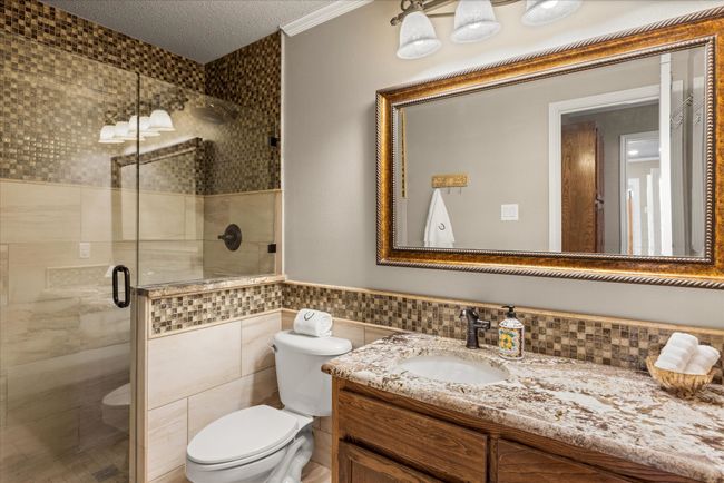 Updated bathroom-granite countertops and large tiled shower. | Image 21